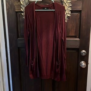Open sweater, long sleeved with small pockets on each side. Burgundy color